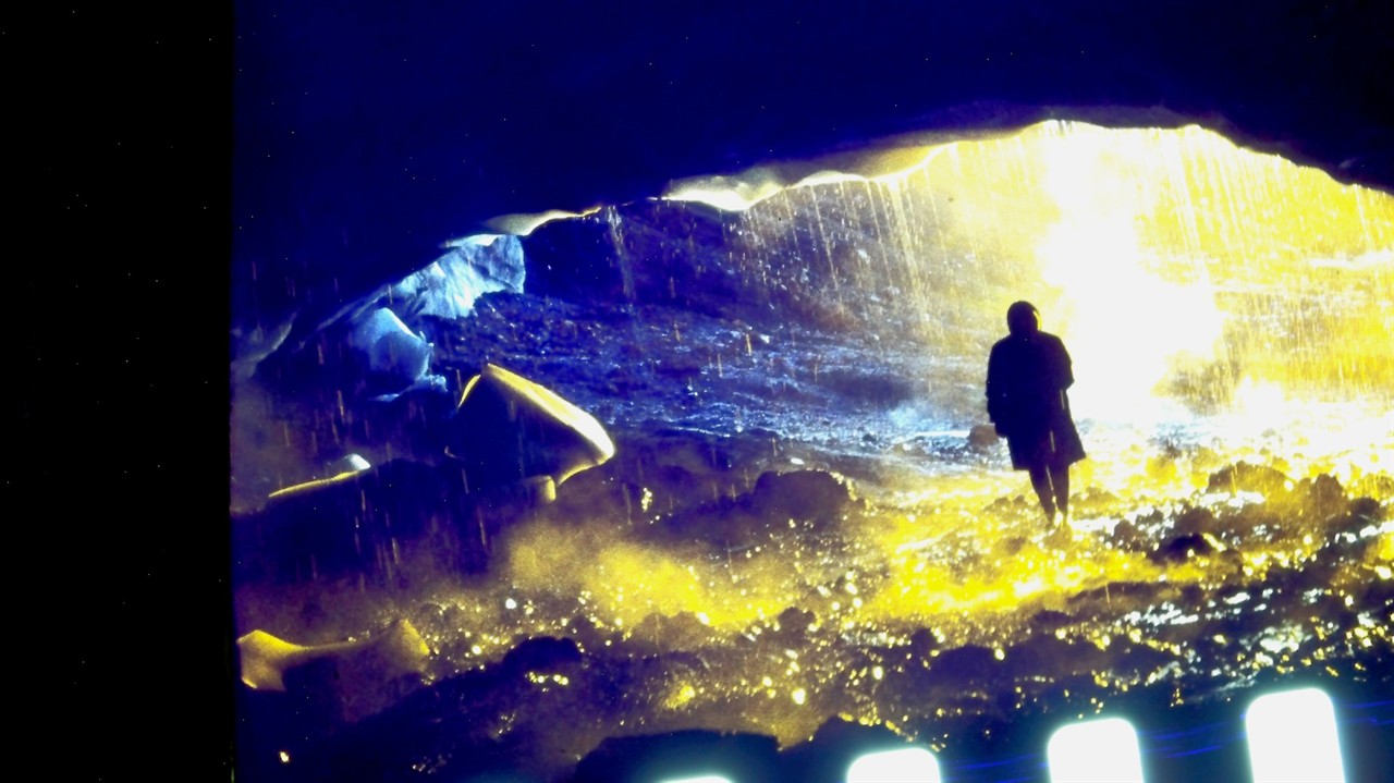 Coloured film negative of a person in a cave